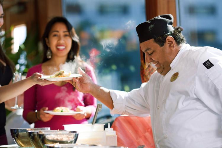 Chef serves guests custom omelets 