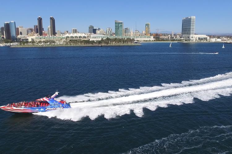 speed boat with backdrop of san diego skyline