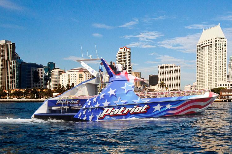 speed boat with backdrop of san diego skyline