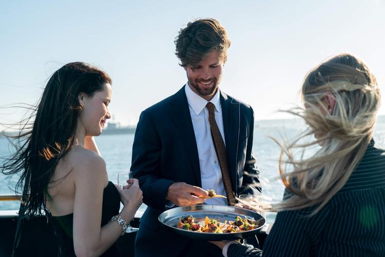 Staff passes horderves during rehearsal dinner cruise