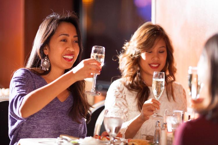 Guests enjoy a champagne and lunch during rehearsal lunch cruise