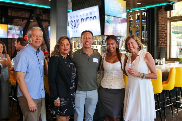 Five people smiling and posing together at the Downtown San Diego Partnership, Quarterly Mixer